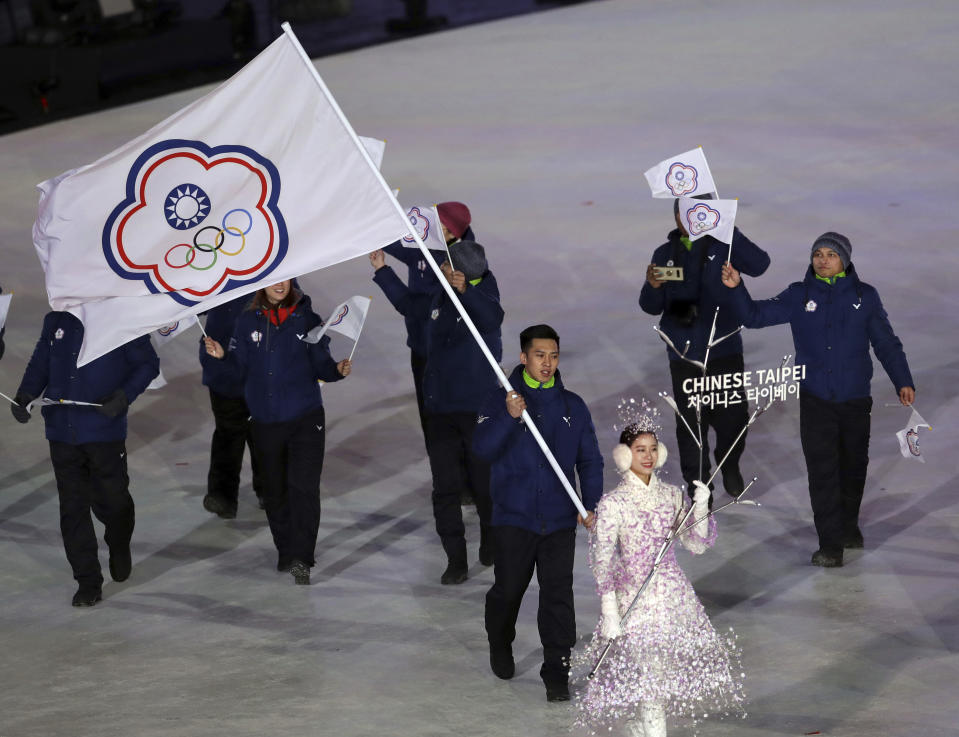 FILE - In this file photo taken Friday, Feb. 9, 2018, Taiwanese athlete Lien Te-An carries the Chinese Taipei flag representing Taiwan during the opening ceremony of the 2018 Winter Olympics in Pyeongchang, South Korea. Taiwan will vote on a referendum this month asking if the self-ruled island should compete as “Taiwan” instead of the present “Chinese Taipei.” This would include the 2020 Olympics in Tokyo. The controversial referendum has angered China, which sees Taiwan as a breakaway province. (AP Photo/Michael Sohn, File)