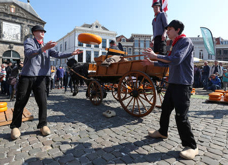 Sellers throw Gouda wheels at the cheese market in Gouda, Netherlands April 18, 2019. REUTERS/Yves Herman