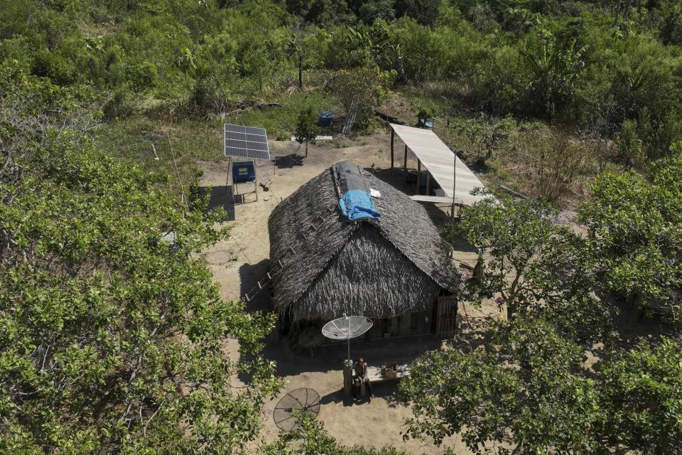 A settler sits outside his house in an area threatened by land-grabbers and illegal cattle farmers in an extractive reserve in Jaci-Parana, Rondonia state, Brazil, Tuesday, July 11, 2023. Meat processing giant JBS SA and three other slaughterhouses are facing lawsuits seeking millions of dollars in environmental damages for allegedly purchasing cattle raised illegally in the area. (AP Photo/Andre Penner)