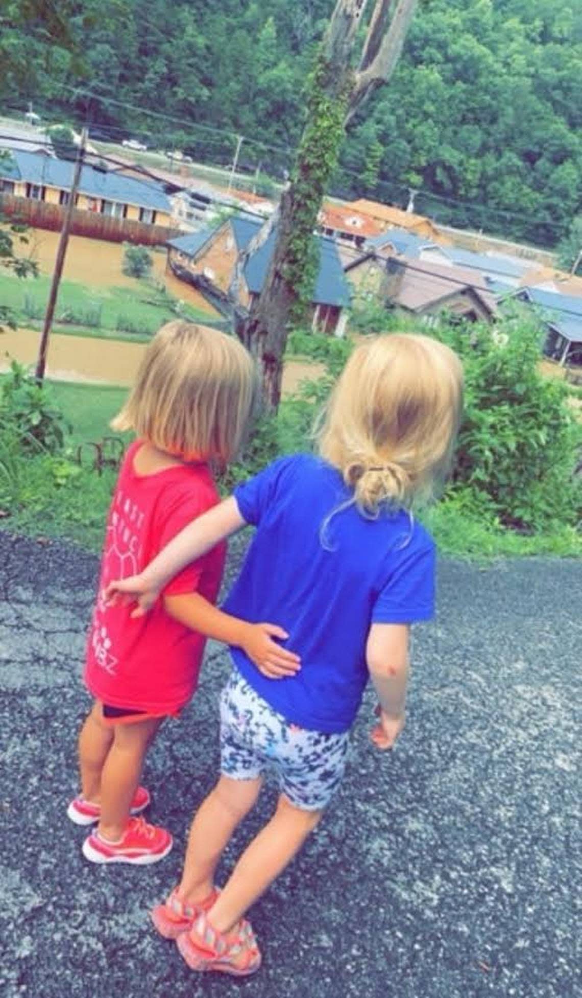 Best preschool friends Tressie Whisenant, 4, left, and Ada Miller, 4, watch from above as their neighbors and friends are being rescued from the flood in Whitesburg, Ky. Ada watched as her house was destroyed and Tressie’s grandmother’s house was destroyed.