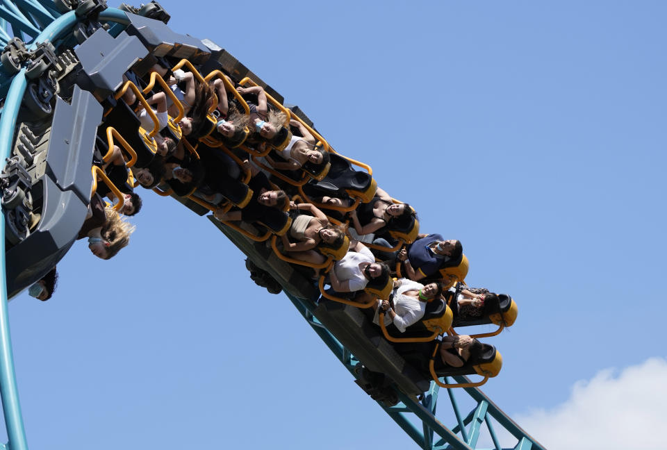 Visitors enjoy a ride on a roller coaster at Cinecitta World amusement park in the outskirts of Rome in the day of its reopening, Thursday, June 17, 2021. Amusement parks have been closed since Oct. 25 2020, when Italy's second national lockdown started. (AP Photo/Alessandra Tarantino)