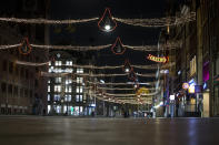 The deserted Damrak street is seen during curfew in the heart of Amsterdam, Saturday, Jan. 23, 2021. The Netherlands entered its toughest phase of anti-coronavirus restrictions to date, imposing a nationwide night-time curfew from 9 p.m. until 4:30 a.m. in a bid to control the COVID-19 infection rate. (AP Photo/Peter Dejong)