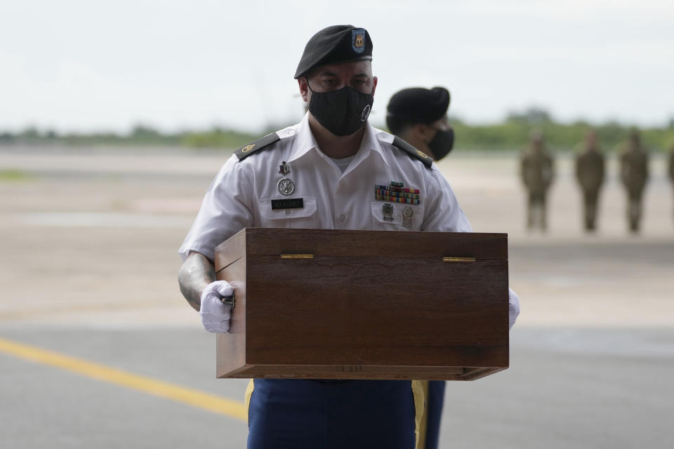 A U.S. Army soldier carries the possible remains of a WWII U.S. airman found in northern Thailand, during a repatriation ceremony Wednesday, May 18, 2022, at the U-Tapao Air Base in Rayong province, eastern Thailand. The possible human remains were found at a crash site in a rice field in northern Thailand by the Defense POW/MIA Accounting Agency and were sent to Hawaii where they will be tested to see if they belong to a U.S. pilot who went missing in 1944. (AP Photo/Sakchai Lalit)