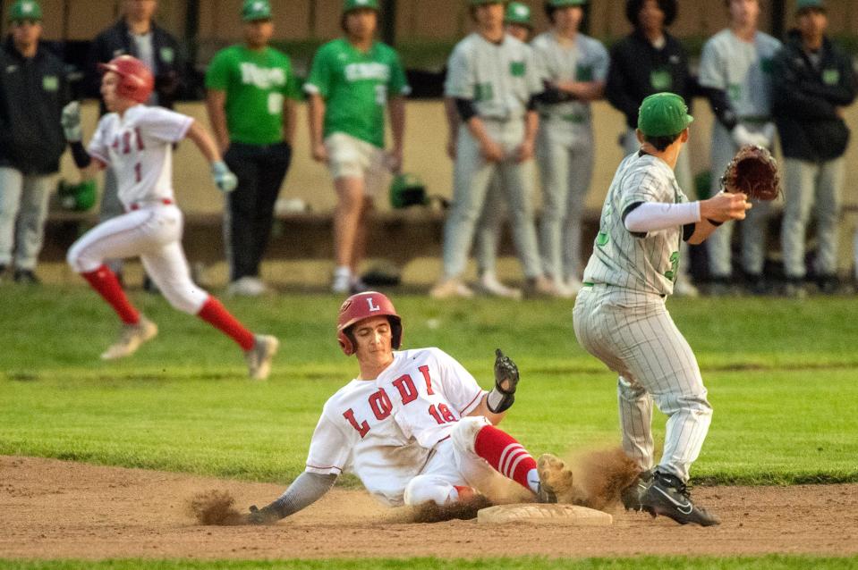 Lodi's Santino,, left is forced out at second as St. Mary's Rolen Reyes attempts the double play during varsity baseball game at Kofu Park in Lodi on Apr. 3, 2024.