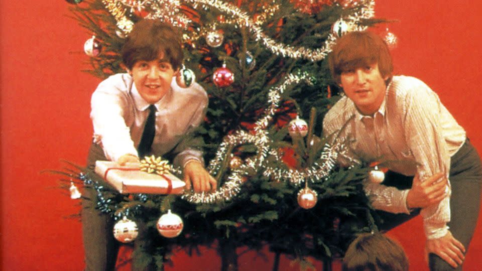Paul McCartney, left, having a "Wonderful Christmastime." - GAB Archive/Redferns/Getty Images