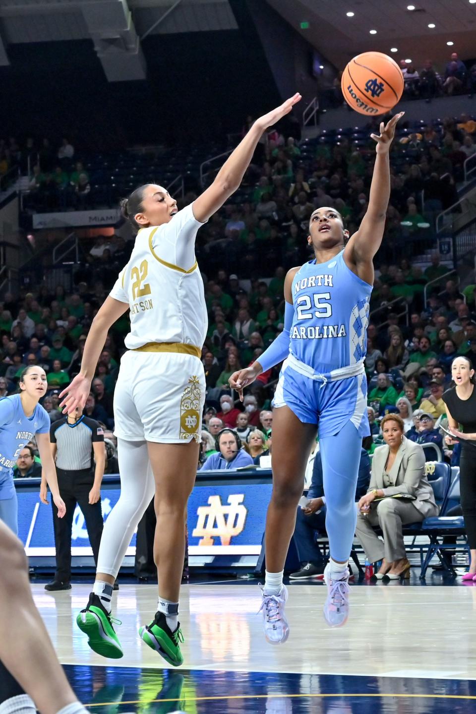 Jan 7, 2024; South Bend, Indiana, USA; North Carolina Tar Heels guard Deja Kelly (25) goes up for a shot as Notre Dame Fighting Irish forward Kylee Watson (22) defends in the first half at the Purcell Pavilion. Mandatory Credit: Matt Cashore-USA TODAY Sports