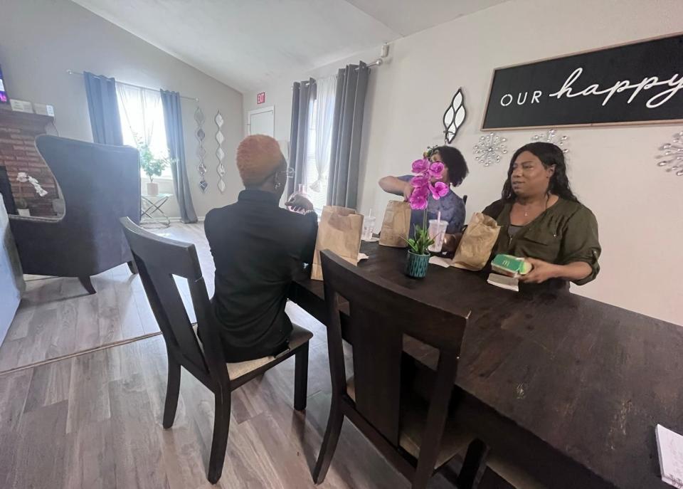 Janel Diaz, right, the founder of the transgender outreach group Capital Tea, shares a meal with residents of the organization’s safe house for transgender women in Tallahassee, Fla.