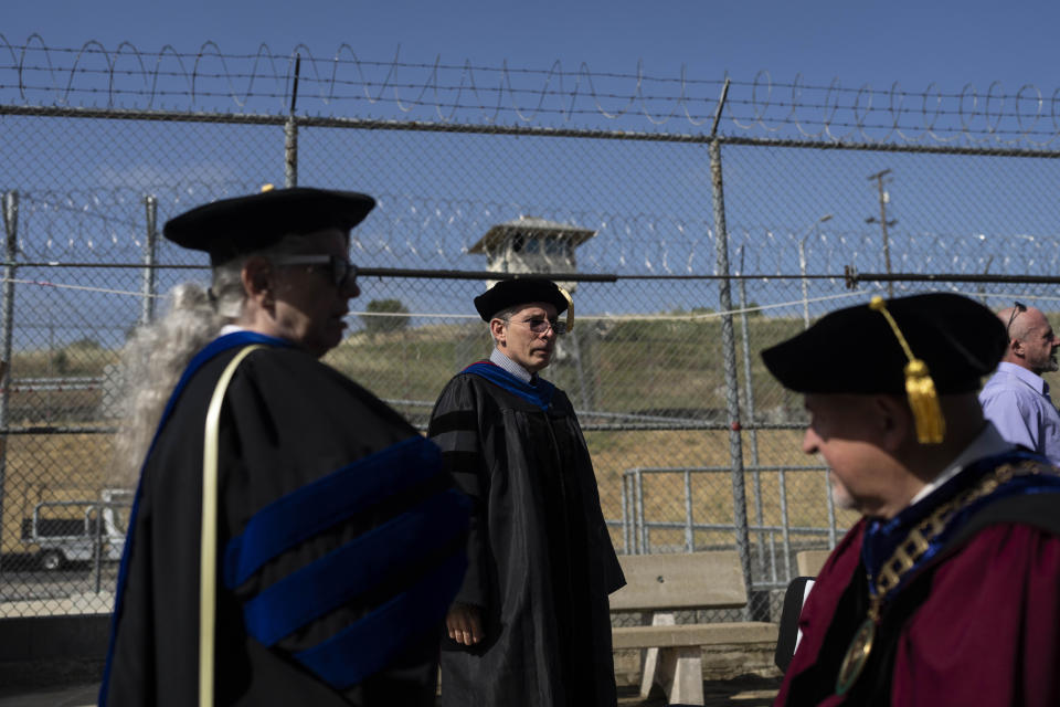 CORRECTS TO ZUCKERMAN, NOT ZUCHERMAN - Sacramento State President Robert Nelson, right, and David Zuckerman, center, the interim director of the Transforming Outcomes Project at Sacramento State (TOPSS), wait for the start of a graduation ceremony at Folsom State Prison in Folsom, Calif., Thursday, May 25, 2023. (AP Photo/Jae C. Hong) corrects to Zuckerman, not Zucherman