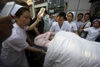 An injured sailor of the ship which sank at the Jianli section of the Yangtze River is rushed to receive treatment upon arrival at a hospital in Jingzhou, Hubei province, China, June 2, 2015. Rescuers fought bad weather on Tuesday as they searched for more than 400 people, many of them elderly Chinese tourists, missing after a ship capsized on the Yangtze River in what was likely China's worst shipping disaster in almost 70 years. (REUTERS/Stringer)