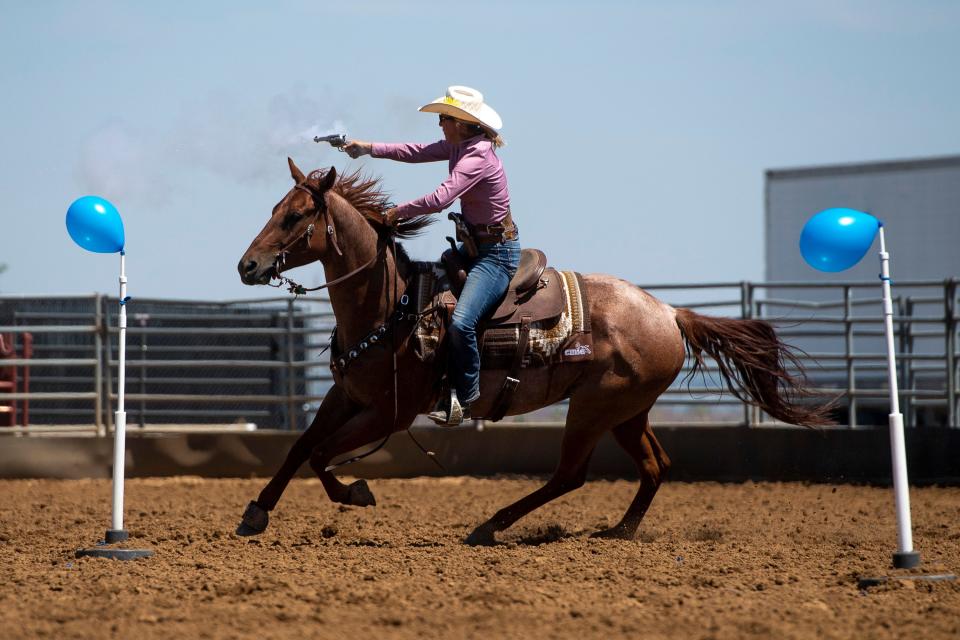 A competitor takes aim at a balloon during the Colorado Outlaw mounted shooting event at the Larimer County Fair and Rodeo at the The Ranch Events Complex in 2022.