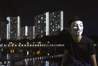 A protester wears a mask in Hong Kong, Friday, Oct. 18, 2019. Hong Kong pro-democracy protesters are donning cartoon/superhero masks as they formed a human chain across the semiautonomous Chinese city, in defiance of a government ban on face coverings. (AP Photo/Vincent Yu)