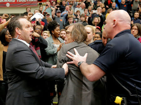 FILE PHOTO: Photographer Christopher Morris is removed by security officials as U.S. Republican presidential candidate Donald Trump speaks during a campaign event in Radford, Virginia February 29, 2016. REUTERS/Chris Keane/File Photo