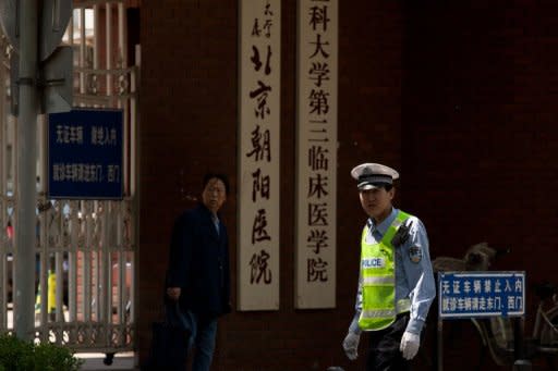 A policeman is seen guarding the entrance to Chaoyang hospital where blind activist Chen Guangcheng is staying, in Beijing, on May 16. More than 10 days after Beijing and Washington reached agreement on his departure, Chen remains confined to a hospital bed as China seeks to show it controls the blind activist's fate