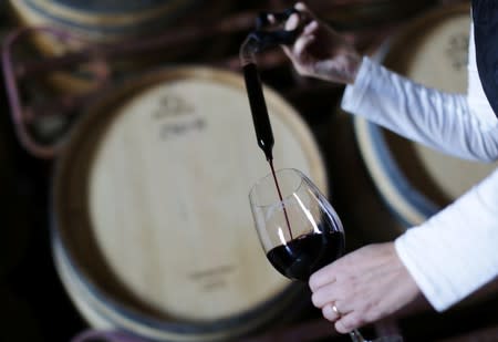 Winemaker Paula Borgo takes a sample of Malbec from a barrel at the Septima winery, in Lujan de Cuyo, in Mendoza Province