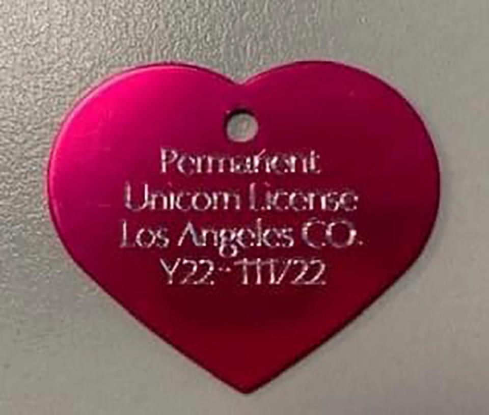 The heart-shaped, rose-colored metal tag with “Permanent Unicorn License” emblazoned on it (AP)