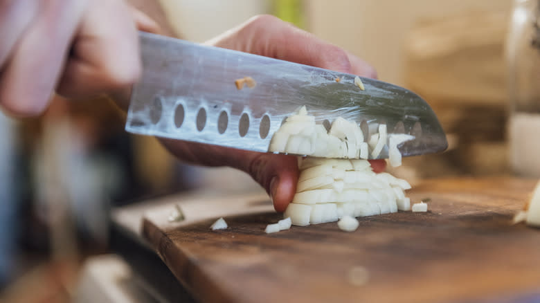 Home cooks chopping onions