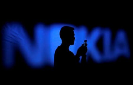 FILE PHOTO: A photo illustration of a man silhouetted against a Nokia logo in the central Bosnian town of Zenica January 23, 2014.      REUTERS/Dado Ruvic/File Photo