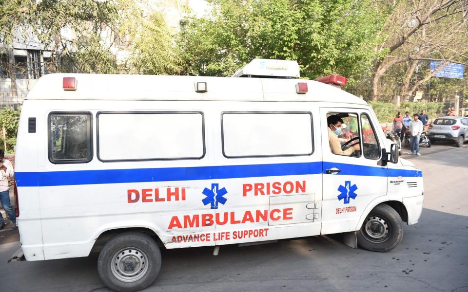 An ambulance carrying the bodies of four executed men enters Deen Dayal Upadhyay hospital in New Delhi  - AFP