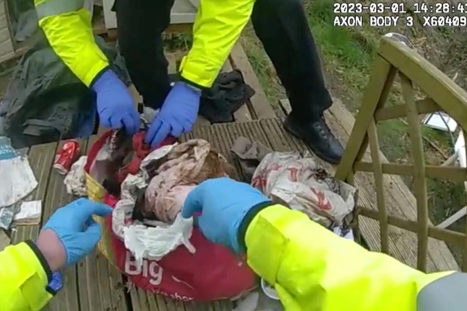 The moment police found the remains of Constance Marten and Mark Gordon's baby covered in leaves in a rubbish-filled shopping bag (Metropolitan Police)