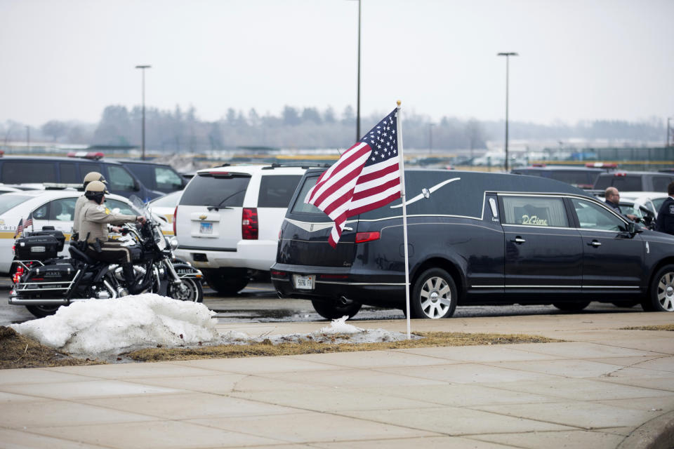 Law enforcement departments from all over the area arrive before funeral services for slain McHenry County Sheriff's Deputy Jacob Keltner on Wednesday, March 13, 2019, at Woodstock North High School in Woodstock, Ill. Keltner was shot and killed while trying to serve an arrest warrant at a hotel on March 7, 2019. (Scott P. Yates/Rockford Register Star via AP)