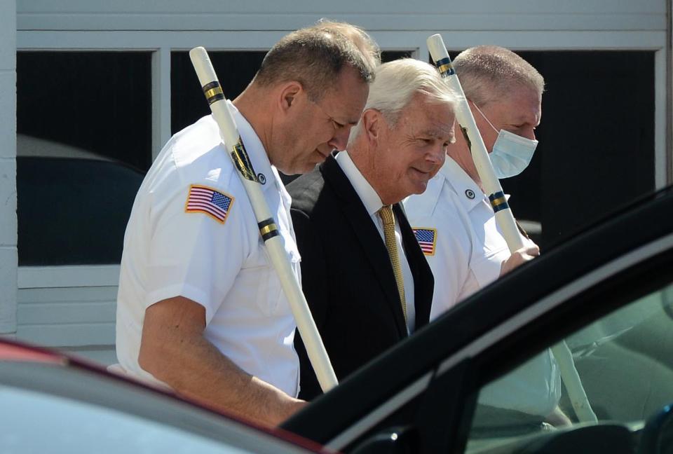 Barnstable Superior Court Judge Mark Gildea is escorted back to a waiting bus by court officers Thursday after the jury in the trial of William Hayes Jr. viewed the area where Darrell Russ was killed.