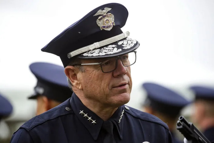 LAPD Chief Michel Moore inspects a graduating class at Los Angeles Police Academy in June.