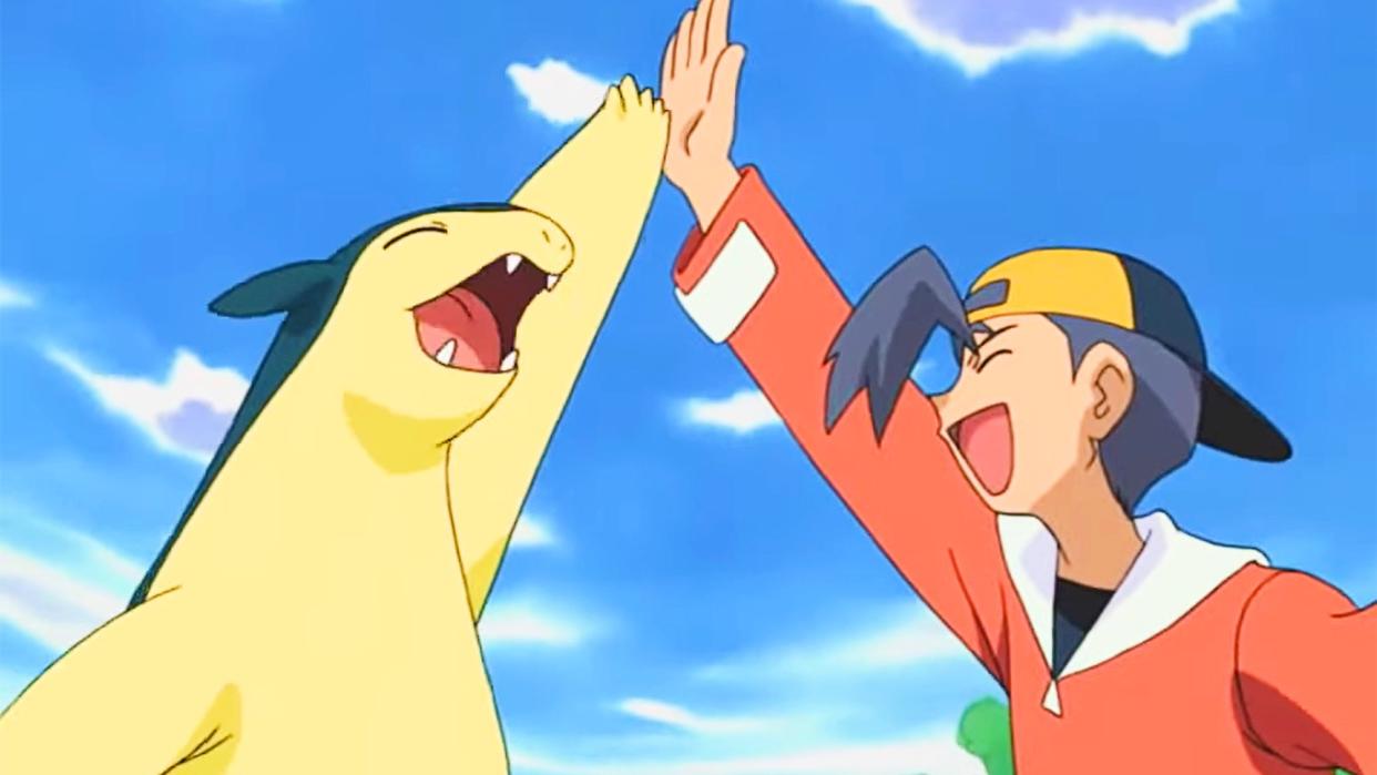  A Typhlosion gives their Pokemon trainer a high-five 