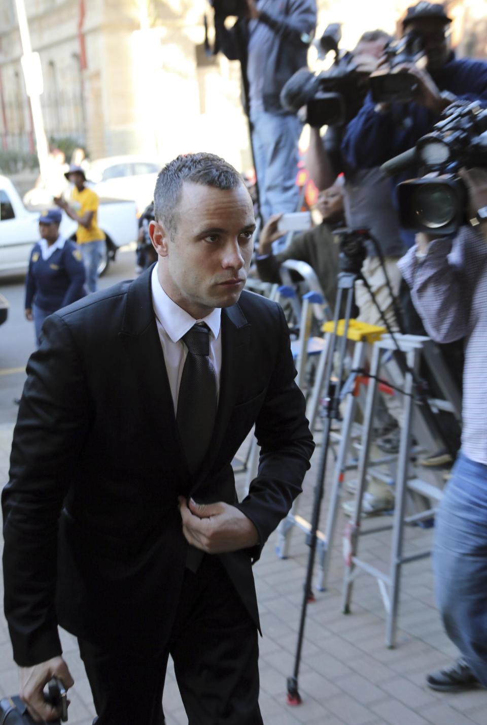 Oscar Pistorius arrives at the high court in Pretoria, South Africa, Monday, March 12, 2014. Pistorius is charged with murder for the shooting death of his girlfriend, Reeva Steenkamp, on Valentines Day in 2013. (AP Photo/Themba Hadebe)