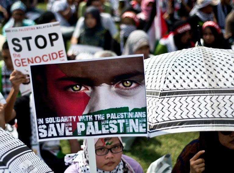 Malaysian activists hold placards during a demonstration in Kuala Lumpur on August 2, 2014, calling for an end to Israel's military offensive in the Gaza Strip