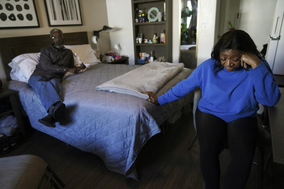 Faye Moore, right, and her partner Garry Betared, left, talk about being evicted from their home as they sit in a hotel room on Wednesday, Nov. 24, 2021, in Morrow, Ga. “I’m devastated. It was a house full of furniture. Everything,” said Moore, a retired mental health therapist. “It was like a storm came in and devastated everything. I can’t find my important papers or anything.” (AP Photo/Brynn Anderson)