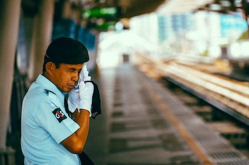 <span class="caption">Phew: heat plus humidity can make Bangkok an uncomfortable place in a heatwave.</span> <span class="attribution"><a class="link " href="https://www.shutterstock.com/image-photo/bangkok-thailand-may-2020-security-guard-1726455493" rel="nofollow noopener" target="_blank" data-ylk="slk:Pavel V.Khon/SHutterstock;elm:context_link;itc:0;sec:content-canvas">Pavel V.Khon/SHutterstock</a></span>