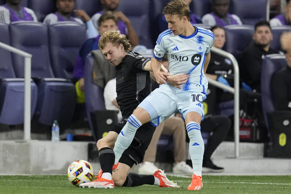 Nashville SC midfielder Jacob Shaffelburg, left, and CF Montréal midfielder Bryce Duke (10) battle for the ball during the first half of an MLS playoff soccer match Saturday, May 4, 2024, in Nashville, Tenn. (AP Photo/George Walker IV)