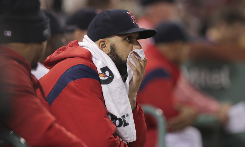 Boston Red Sox starting pitcher David Price watches a game against the San Francisco Giants from the dugout during the sixth inning of a baseball game at Fenway Park in Boston, Tuesday, Sept. 17, 2019. (AP Photo/Charles Krupa)