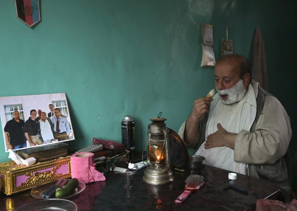 Zabulon Simantov, an Afghan Jew, shaves at his residence in Kabul