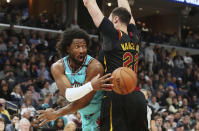 Memphis Grizzlies forward Solomon Hill (44) passes the ball as Cleveland Cavaliers forward Larry Nance Jr. (22) defends during the first half of an NBA basketball game Friday, Jan. 17, 2020, in Memphis, Tenn. (AP Photo/Karen Pulfer Focht)