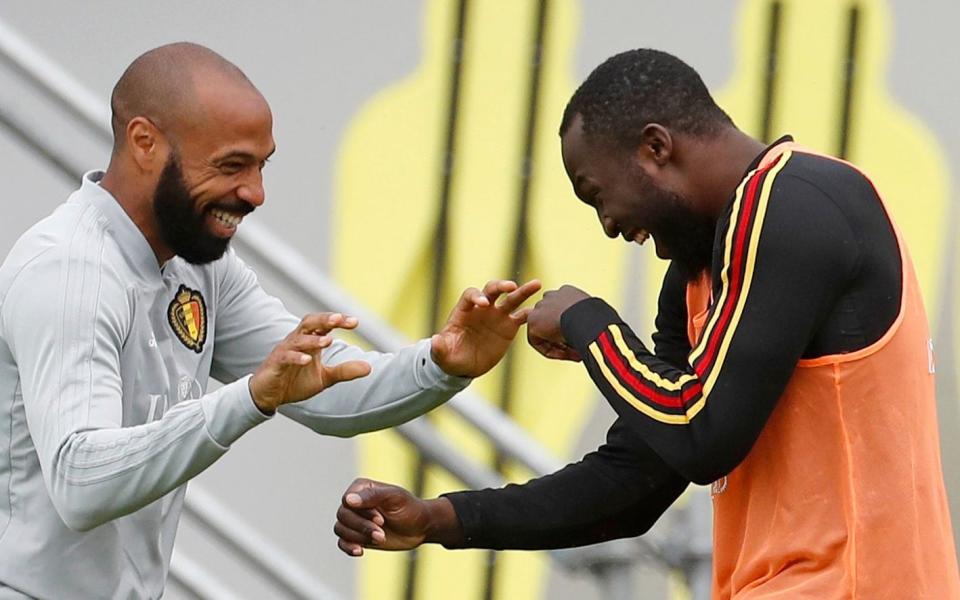 Belgium assistant coach Thierry Henry, left, jokes with Belgium's Romelu Lukaku during a training session on the eve of the semifinal against France at the 2018 soccer World Cup in Moscow - AP Photo/Alexander Zemlianichenko