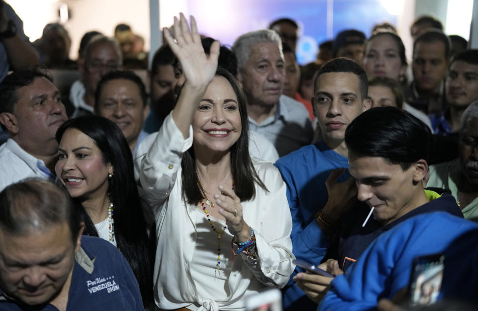 Opposition presidential hopeful Maria Corina Machado, center, celebrates with supporters after listening to the results naming her winner of the opposition primary election, at her campaign headquarters in Caracas, Venezuela, early Monday, Oct. 23, 2023. (AP Photo/Ariana Cubillos)