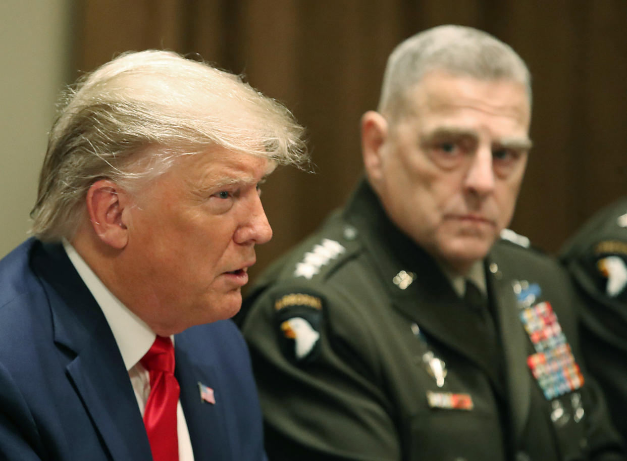 Former President Donald Trump speaks at the White House, as the chairman of the joint chiefs of staff, Army Gen. Mark Milley, looks on in October 2019.