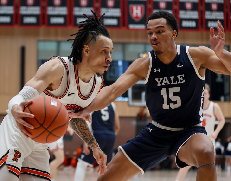 Princeton guard Jaelin Llewellyn drives against Yale forward EJ Jarvis (15) during the first half of an NCAA Ivy League men's college basketball championship game, Sunday, March 13, 2022, in Cambridge, Mass. (AP Photo/Mary Schwalm)