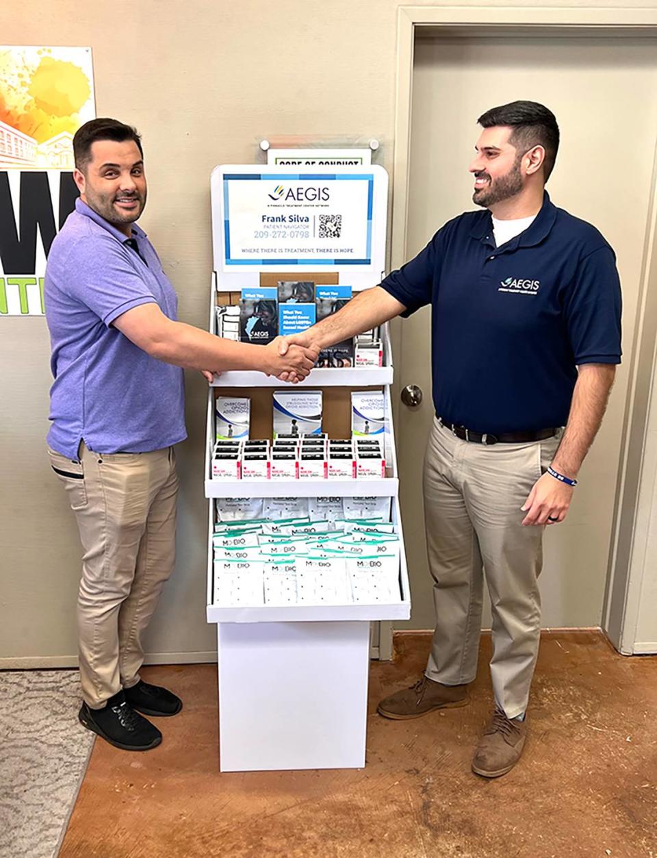 Gerad Amore, executive director of Rainbow Resource Center, left, and Frank Silva, patient navigator for Pinnacle Treatment Centers, next to a display filled with Narcan dispensers, fentanyl test strips and xylazine test strips. Pinnacle Treatment Centers are providing the harm reduction displays at the Rainbow center at 1202 H St. downtown Modesto, Modesto Junior College west campus and Weave community center, at 820 H St.