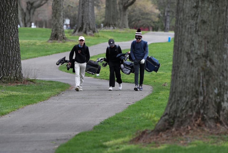 A trio of teens walk along the first fairway at the Cherokee Golf Course in Louisville, Ky. on April 17, 2022.  There is discussion about converting the golf course into a walking trail.