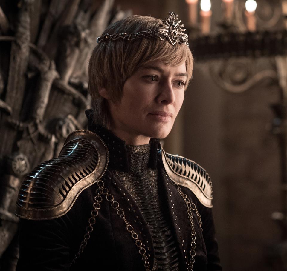 Seven seasons later, she's queen again, but under very different circumstances that are evident in every element of her costuming. Gone are her long golden waves, replaced by a <a href="https://www.allure.com/story/cersei-lannister-lena-headey-platinum-wig?mbid=synd_yahoo_rss" rel="nofollow noopener" target="_blank" data-ylk="slk:tight helmet of short strands;elm:context_link;itc:0;sec:content-canvas" class="link ">tight helmet of short strands</a>, crowned with a simple circlet. Her makeup is still fairly light, but her eyes are more heavily emphasized, and her lip color has transitioned from pinks to a matte nude. Also gone are the light, flowing dresses, replaced by heavy brocade and velvet, with chain detailing and armored shoulders that can do nothing to shield her from all the loss she's endured over the past few seasons.