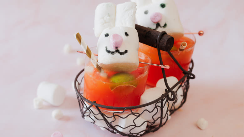 Two bunny topped drinks in egg basket