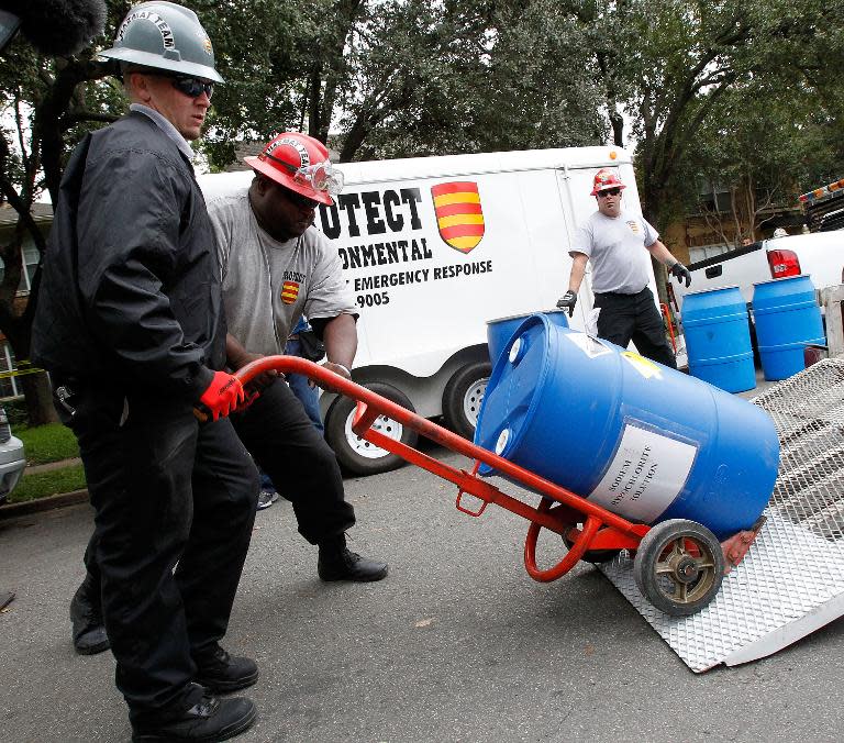 Hazmat workers outside an apartment where a second person diagnosed with the Ebola virus lives on October 13, 2014 in Dallas, Texas