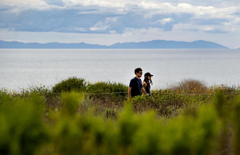 NEWPORT BEACH, CA - MARCH 20, 2020: Day hikers enjoy the nature trail and sea air after Gov. Gavin Newsom ordered a "stay at home" mandate to curtail the spread of the coronavirus at Crystal Cove State Park on March 20, 2020 in Newport Beach, California. The mandate allows for residents to go outside and get exercise as long as they maintain social distancing.(Gina Ferazzi/Los AngelesTimes)