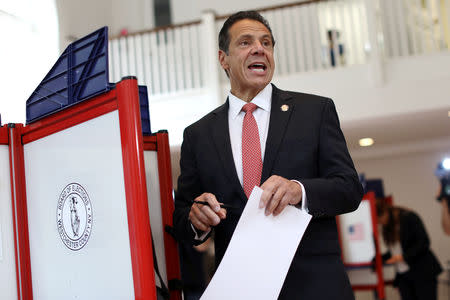 New York Governor Andrew Cuomo holds his ballot while voting in the New York Democratic primary election at the Presbyterian Church in Mt. Cisco, New York, U.S., September 13, 2018. REUTERS/Mike Segar