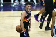 Phoenix Suns guard Devin Booker shouts in celebration in the closing seconds during the second half of Game 1 of the NBA basketball Western Conference finals against the Los Angeles Clippers, Sunday, June 20, 2021, in Phoenix. The Suns defeated the Clippers 120-114. (AP Photo/Ross D. Franklin)