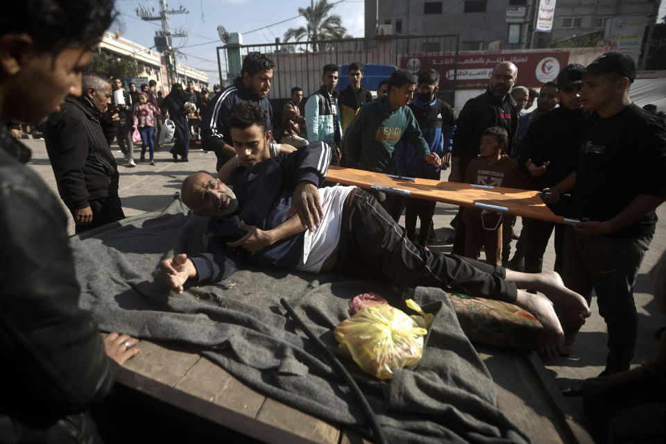 A Palestinian man wounded in the Israeli bombardment of the Gaza Strip is brought to the hospital on a donkey cart in Khan Younis, Gaza Strip, Friday, Dec. 29, 2023. (AP Photo/Mohammed Dahman)