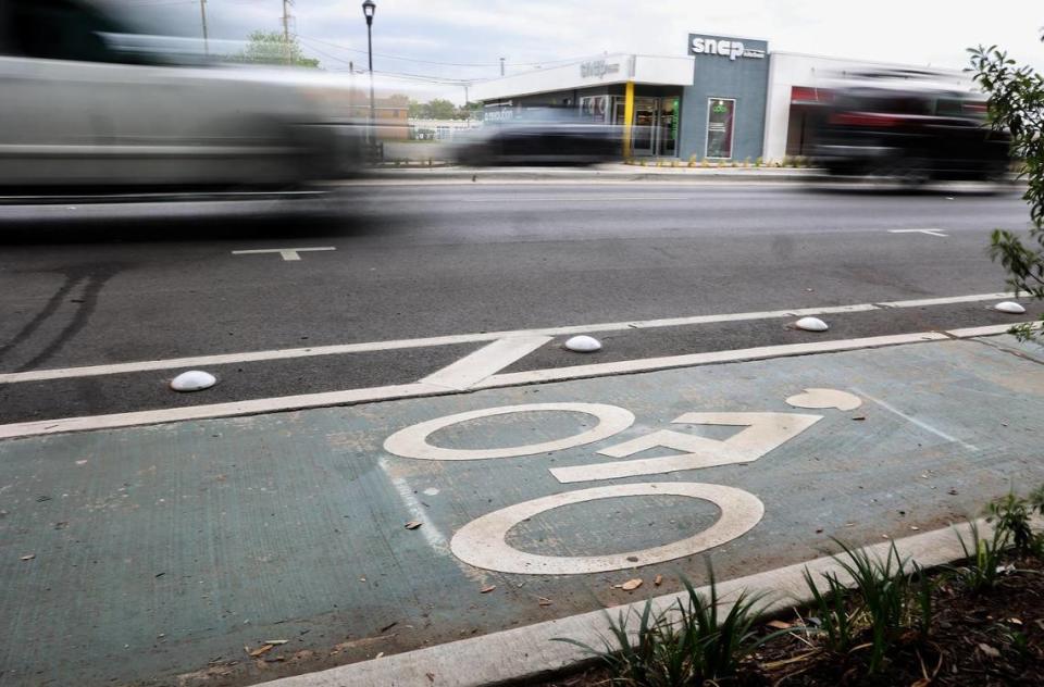 Cars drive beside the new bike lane on West 7th Street in Fort Worth on Tuesday, April 18, 2023. Fort Worth taxpayers spent $8.5 million for road improvements on a stretch of West 7th Street between University Drive and the Trinity River.