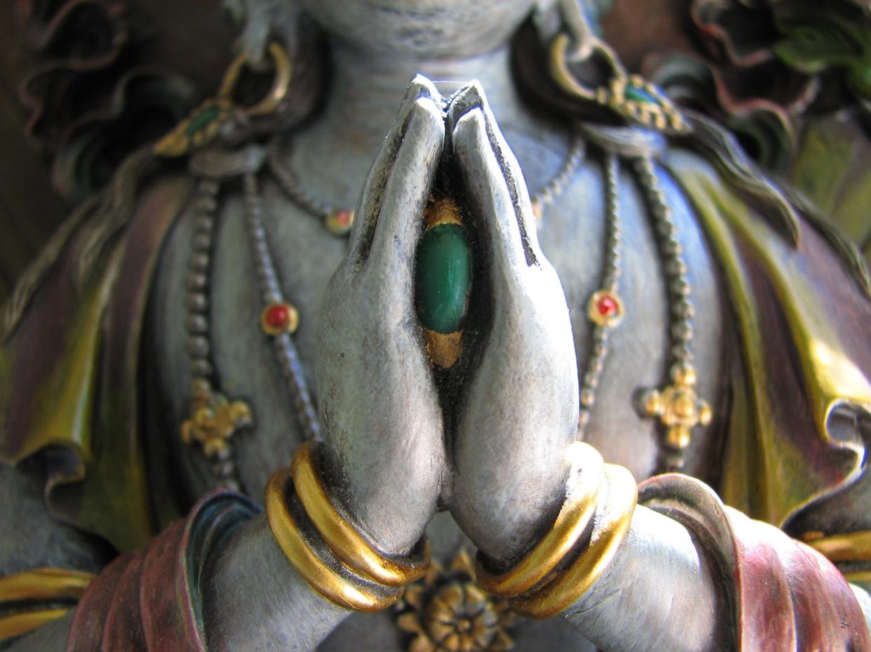 Avalokiteshvara, the bodhisattva of compassion, holding a jewel between his folded hands. <a href="https://www.gettyimages.com/detail/photo/avalokiteshvara-royalty-free-image/107075085?adppopup=true" rel="nofollow noopener" target="_blank" data-ylk="slk:Debbie Hemenway/Moment via Getty images;elm:context_link;itc:0;sec:content-canvas" class="link ">Debbie Hemenway/Moment via Getty images</a>